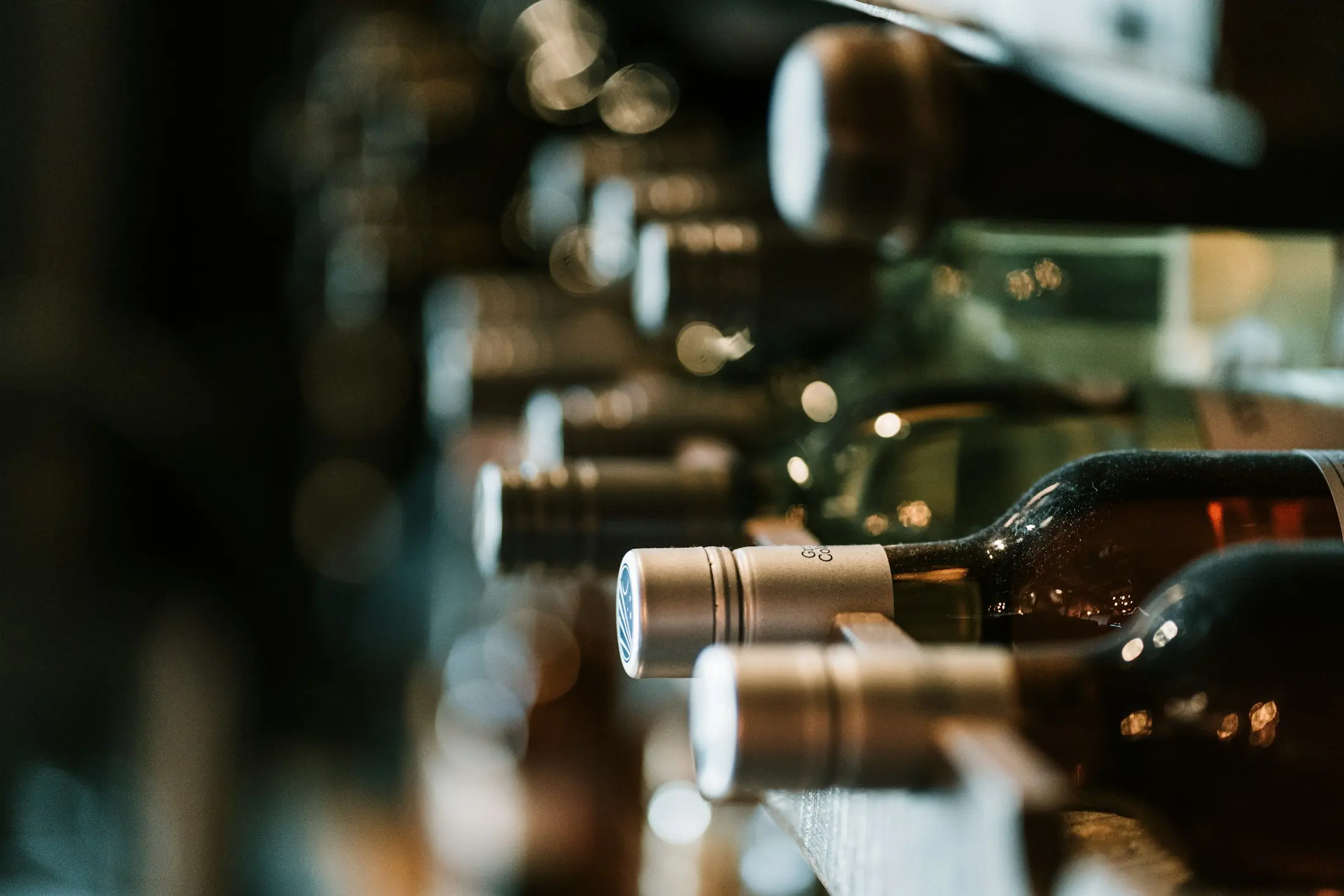 Bottles resting on their sides in the cellar racks