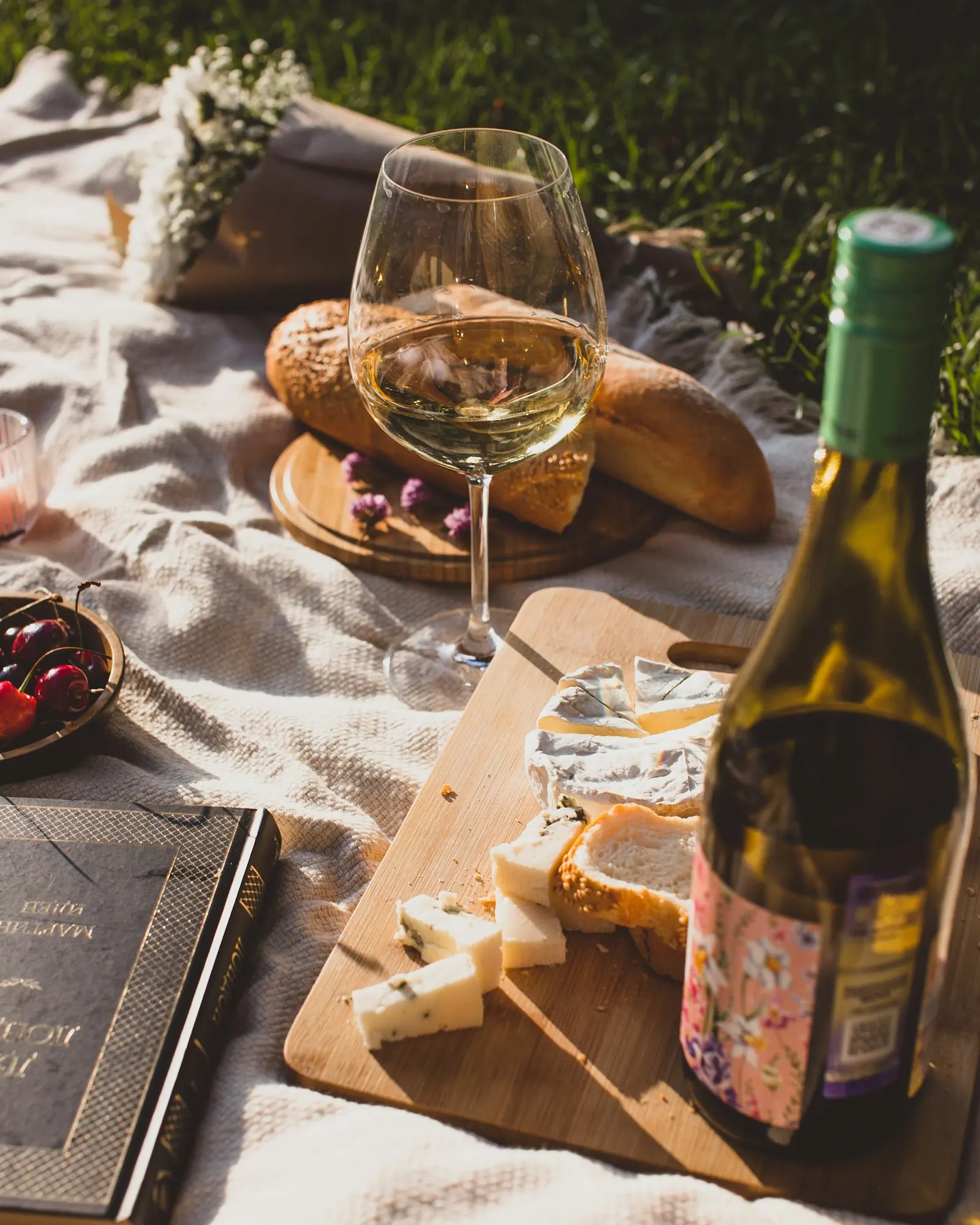 Fruit and bottles laid out on a table at the edge of the vineyard